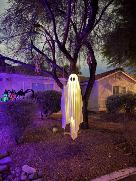 Hanging ghost decoration glowing at night